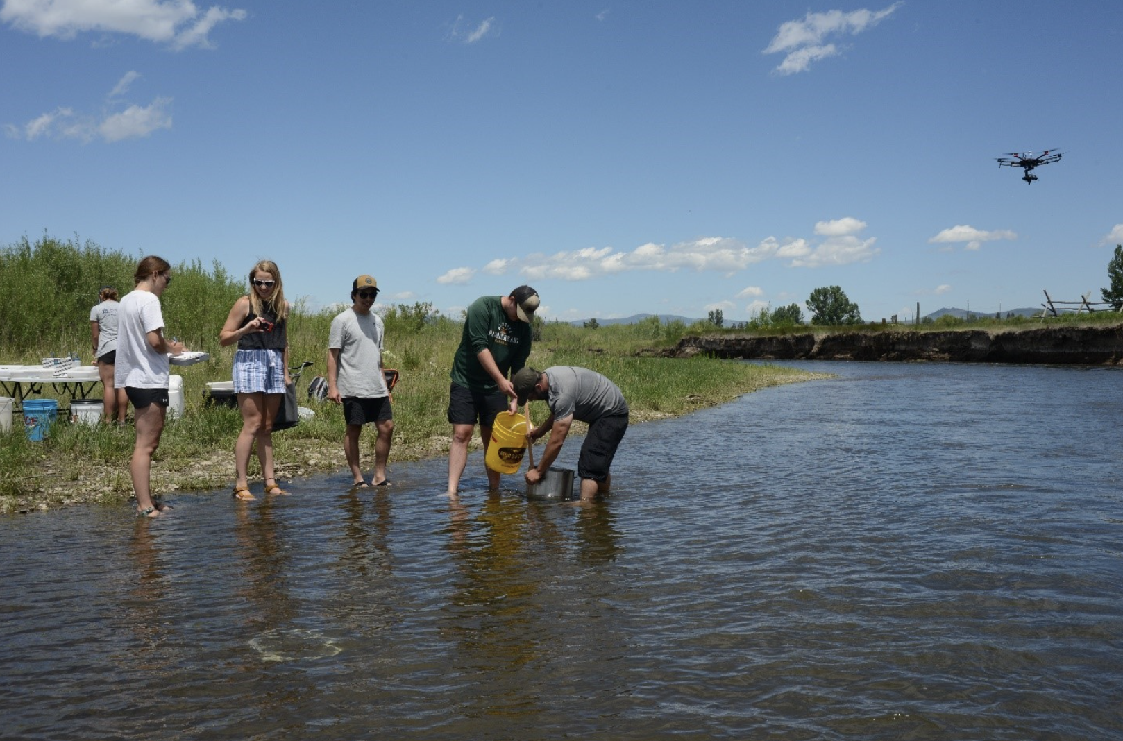 Researchers working in a river to collect samples