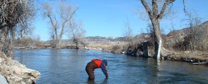 A volunteer takes a water sample on the Crow Indian Reservation. MSU photo.